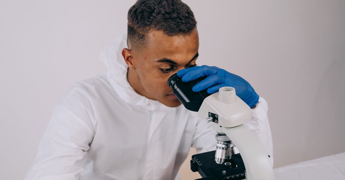 Doing research on ESTA / J-1 visa - A Man in Coveralls Using a Microscope Doing research on ESTA / J-1 visa - A Man in Coveralls Using a Microscope