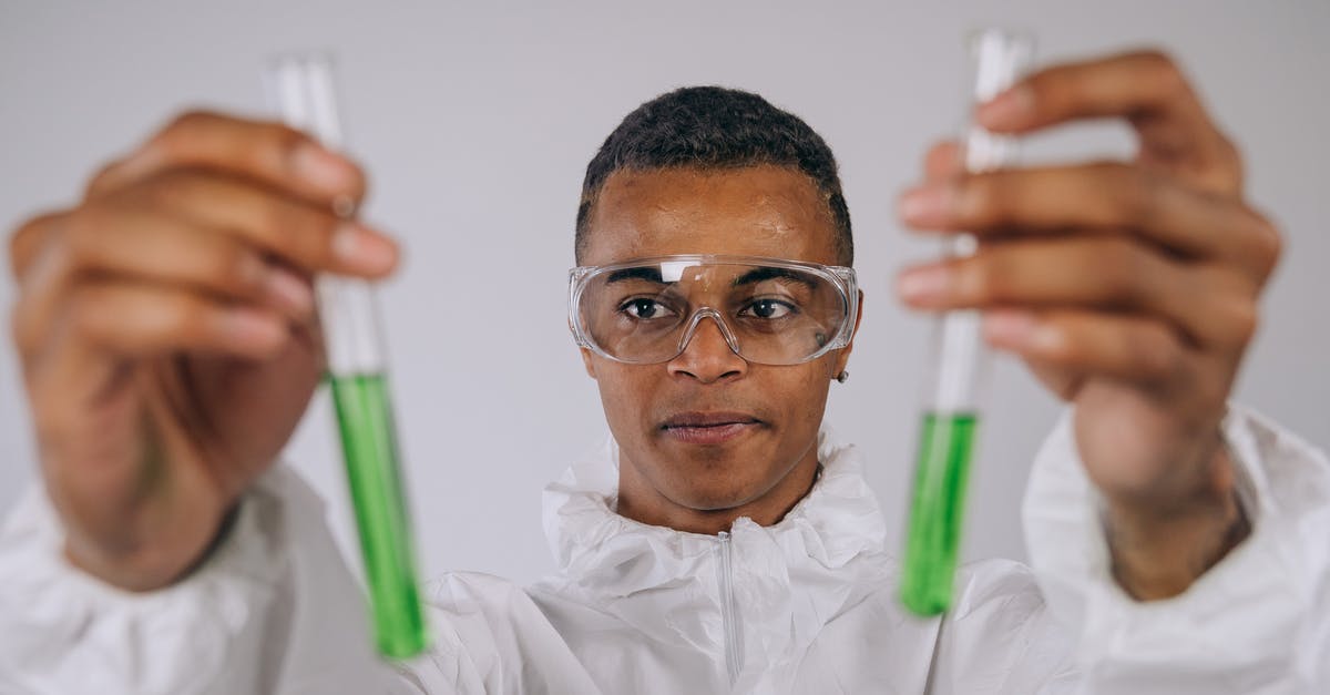 Doing research on ESTA / J-1 visa - A Man Wearing Test Tubes With Green Liquid Doing research on ESTA / J-1 visa - A Man Wearing Test Tubes With Green Liquid