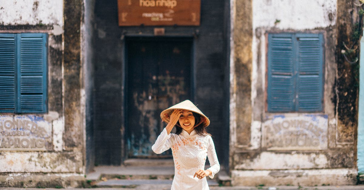 Dos and don'ts at a Vietnamese wedding - Woman Wearing a Conical Hat Standing on a Street Dos and don'ts at a Vietnamese wedding - Woman Wearing a Conical Hat Standing on a Street