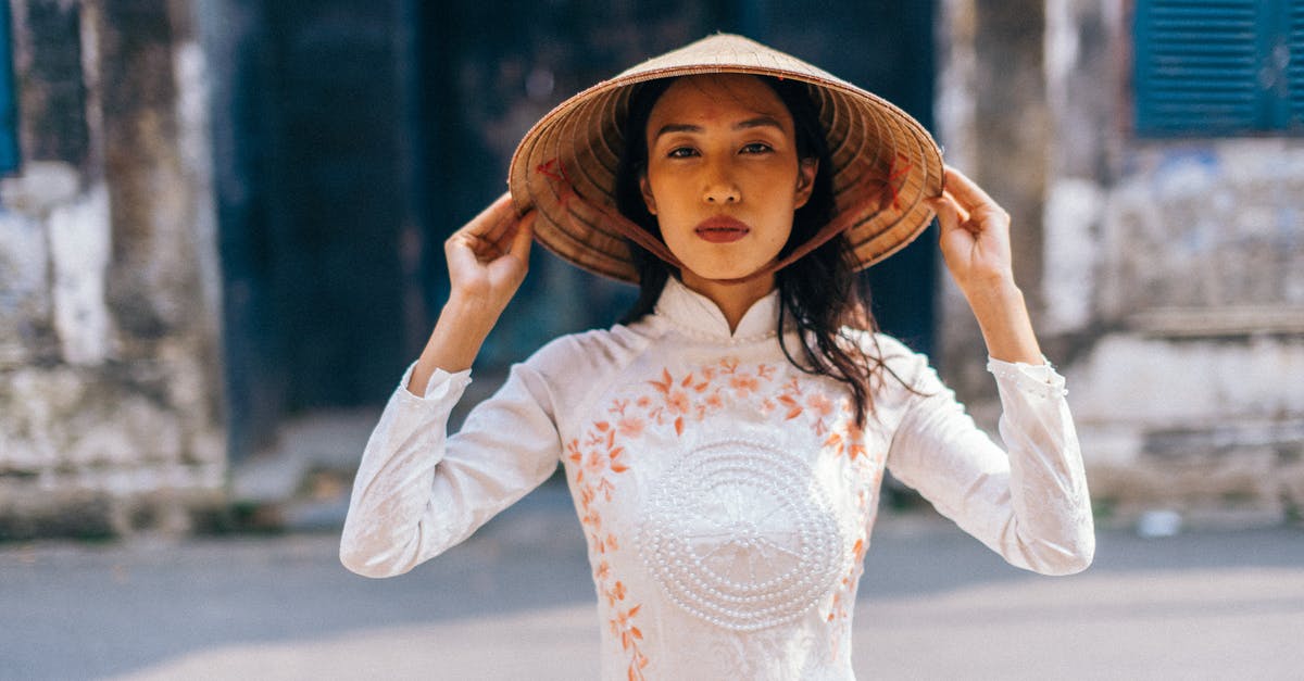 Dos and don'ts at a Vietnamese wedding - Woman Wearing a Conical Hat Looking at Camera Dos and don'ts at a Vietnamese wedding - Woman Wearing a Conical Hat Looking at Camera