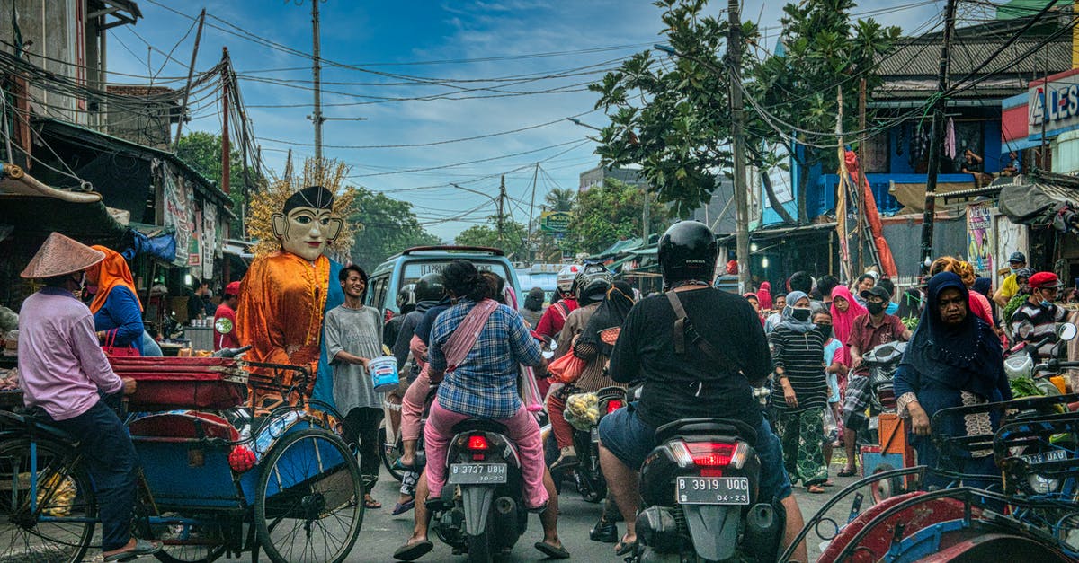 driving abroad with own car and local law on modifications, differences between what's is legal on a car and what isn't - Ethnic people walking of crowded street near road with cars and motorcycles in Asian town driving abroad with own car and local law on modifications, differences between what's is legal on a car and what isn't - Ethnic people walking of crowded street near road with cars and motorcycles in Asian town