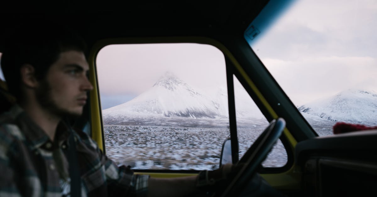 Driving in North and South Carolina with an Indian driving licence? - Man driving automobile along frozen field with mountains in distance Driving in North and South Carolina with an Indian driving licence? - Man driving automobile along frozen field with mountains in distance