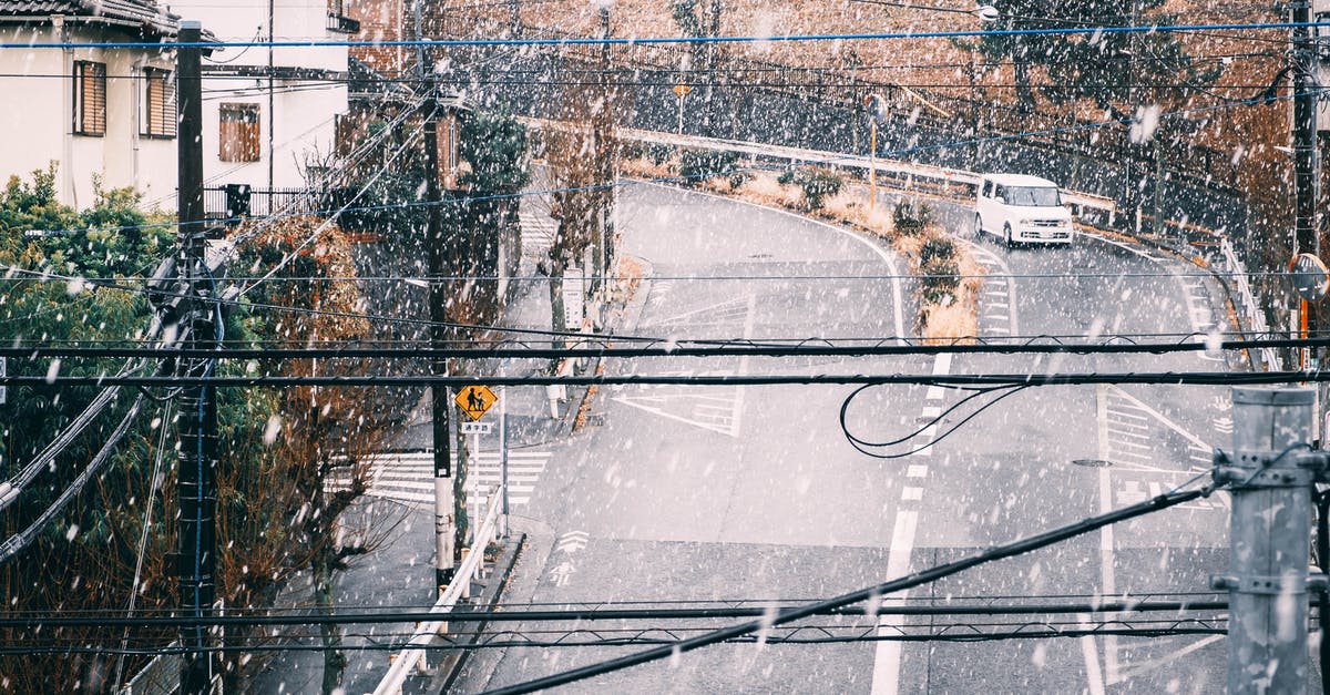 Driving in the winter (Dec-Jan) from Ohio to California - Car driving on railroad in residential district on snowy day Driving in the winter (Dec-Jan) from Ohio to California - Car driving on railroad in residential district on snowy day