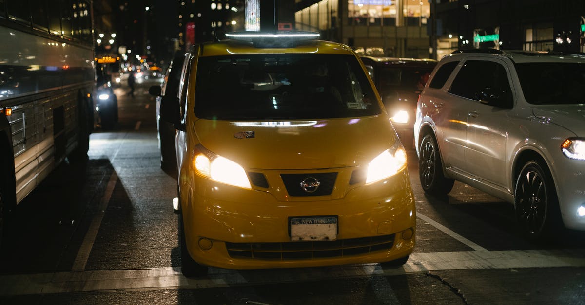 Driving in U.S. (Hawaii) with EU license written in Czech - Shiny cab and automobiles driving on night city street Driving in U.S. (Hawaii) with EU license written in Czech - Shiny cab and automobiles driving on night city street