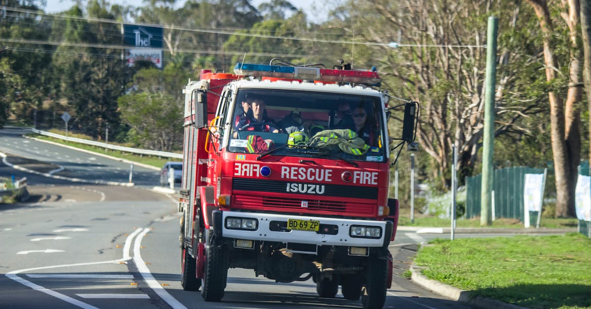 Driving license in Australia - Red Fire Truck With Firemen On The Road Driving license in Australia - Red Fire Truck With Firemen On The Road