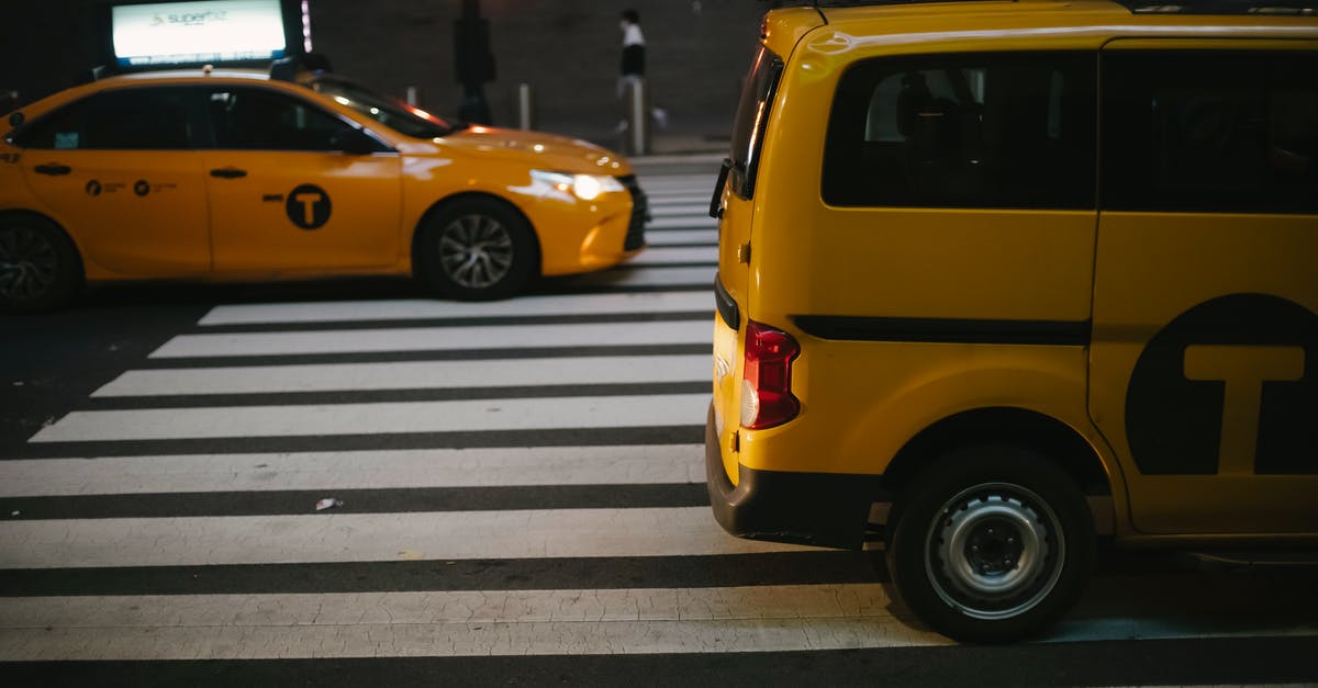 Driving moving van towing car Nashville to salt lake best route?... [closed] - Various shiny yellow cabs driving on street in evening