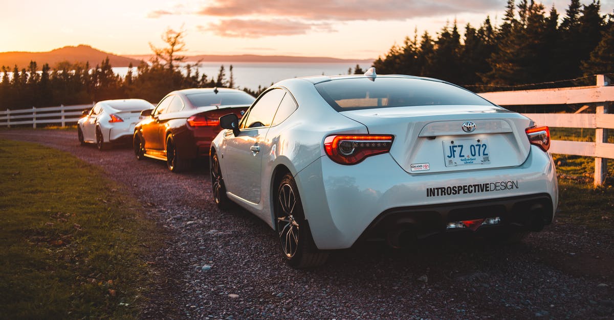 Driving moving van towing car Nashville to salt lake best route?... [closed] - Stylish coupe automobiles riding on rural hilly road near fir trees leading to lake against sundown sky