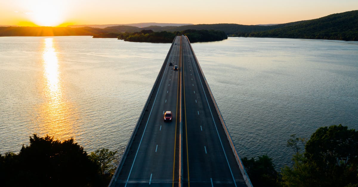 Driving moving van towing car Nashville to salt lake best route?... [closed] - Cars on road bridge over lake at sundown