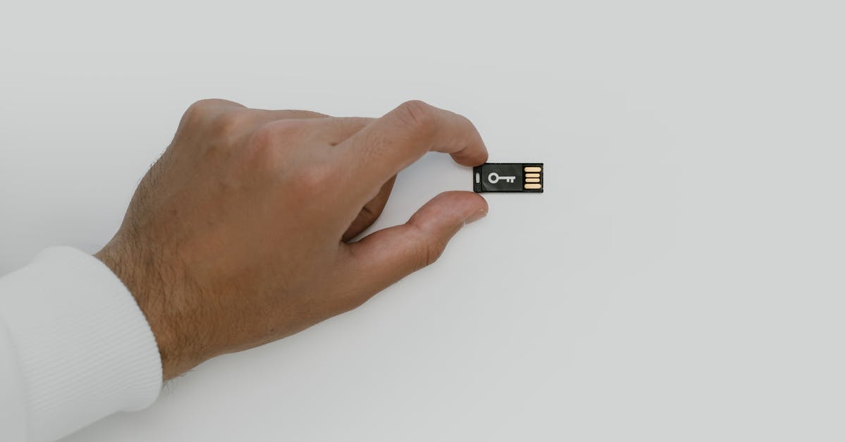 DS-160 Security and Background Information for UK Banned Applicants - Hand Holding a USB Flash Drive DS-160 Security and Background Information for UK Banned Applicants - Hand Holding a USB Flash Drive