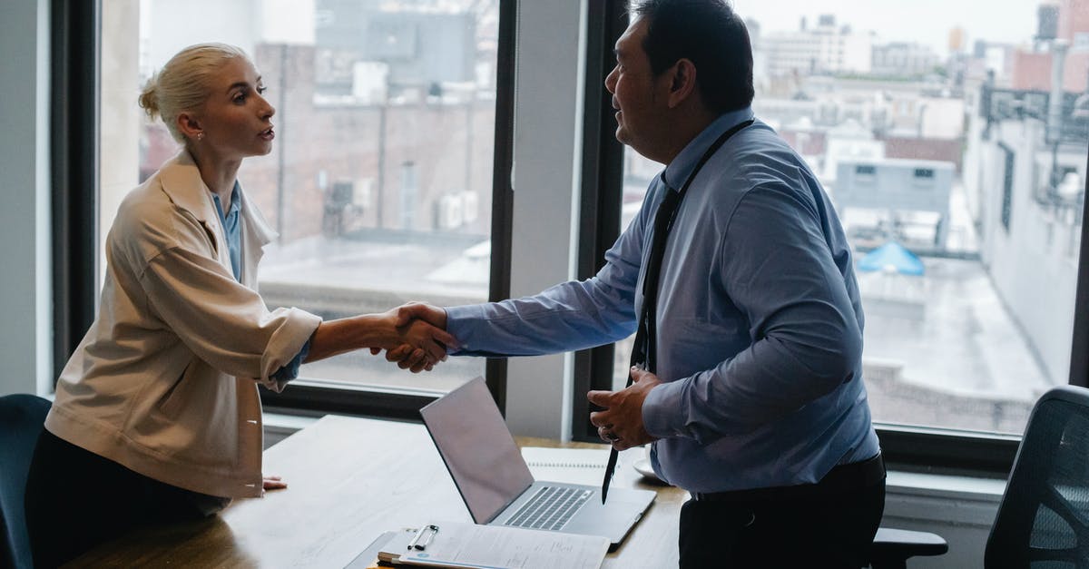 DS160 vs Appointment Interview Location - Young woman shaking hands with boss after business presentation DS160 vs Appointment Interview Location - Young woman shaking hands with boss after business presentation