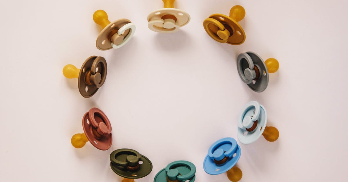 DS -160 form and fee for baby - Set of multicolored baby pacifiers on table DS -160 form and fee for baby - Set of multicolored baby pacifiers on table
