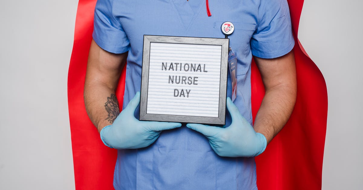 Dual nationality - France<->Russia with ID card - Doctor in red cape showing letterboard with National nurse day inscription Dual nationality - France<->Russia with ID card - Doctor in red cape showing letterboard with National nurse day inscription