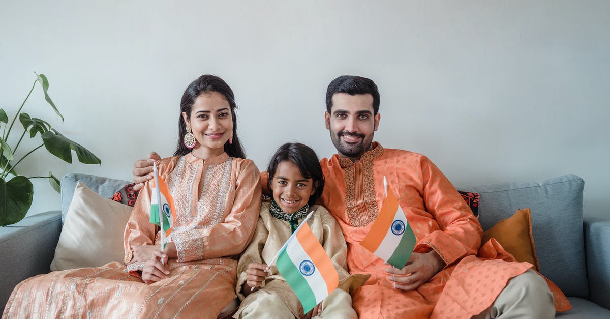 Dual nationality and ESTA - Man in Orange Polo Shirt Sitting Beside Woman in Orange Long Sleeve Shirt Dual nationality and ESTA - Man in Orange Polo Shirt Sitting Beside Woman in Orange Long Sleeve Shirt