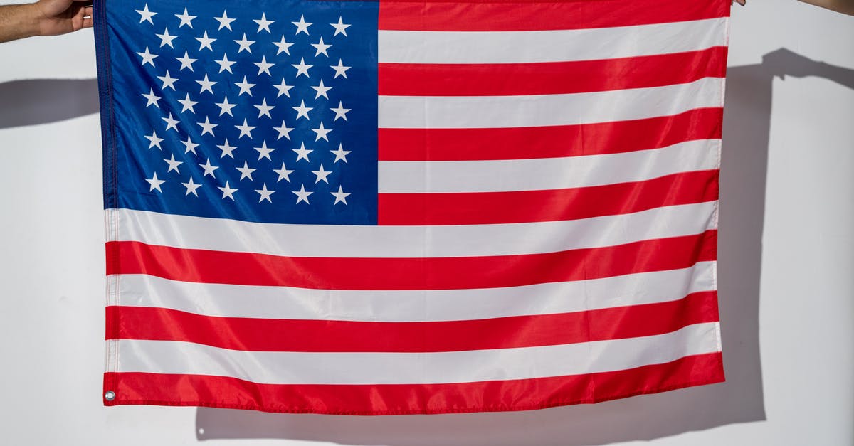 Dual-nationality traveling to US (EU + other nonwaiver country holding paper visa) - Hands Holding an American Flag Dual-nationality traveling to US (EU + other nonwaiver country holding paper visa) - Hands Holding an American Flag