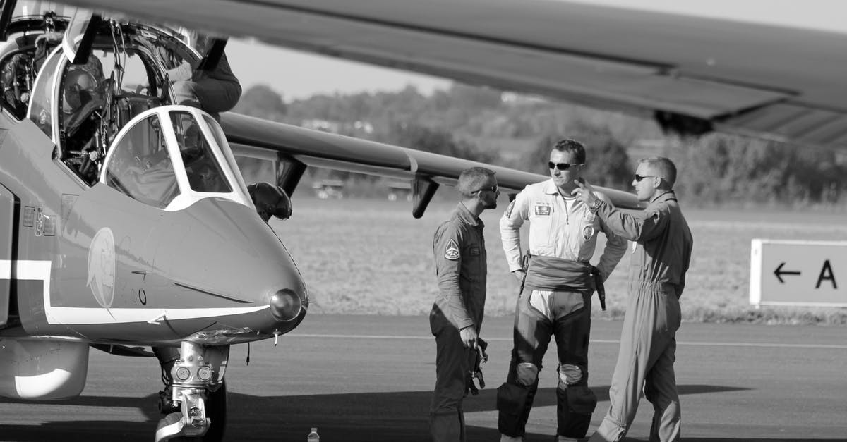 Dubai airport enquiries - Grayscale Photo of 2 Men Standing Near Airplane Dubai airport enquiries - Grayscale Photo of 2 Men Standing Near Airplane