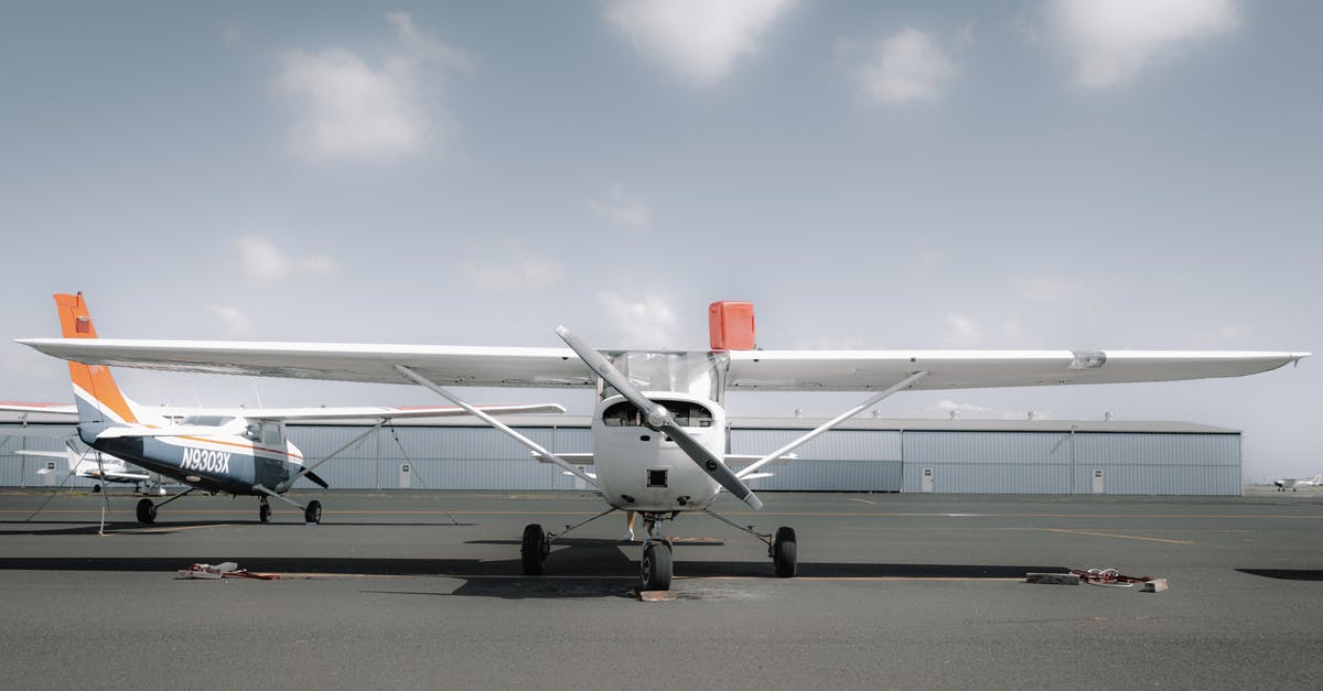 Dubai International Airport services - Contemporary high wing airplane parked near airport on sunny day Dubai International Airport services - Contemporary high wing airplane parked near airport on sunny day