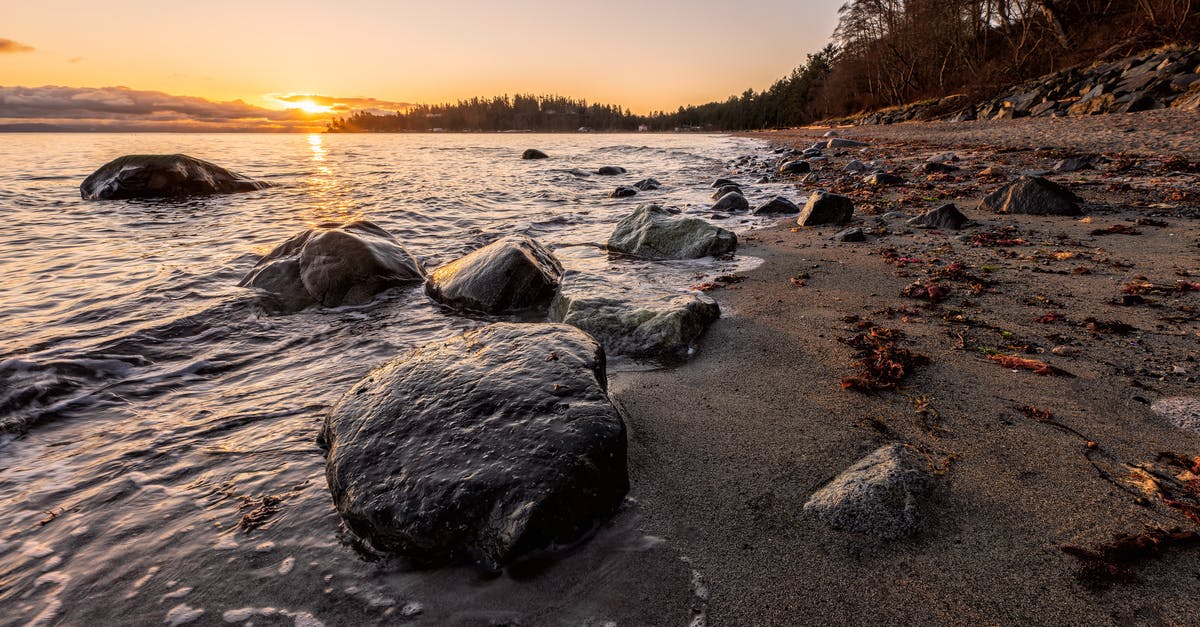 Dublin-Newark-Vancouver. Two-hour layover - Gray Rocks on Seashore during Sunset Dublin-Newark-Vancouver. Two-hour layover - Gray Rocks on Seashore during Sunset
