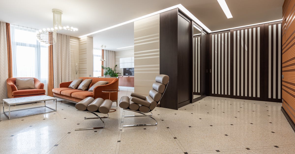 During COVID, which Schengen Zone countries can be entered through non-Schengen corridor countries, without quarantine? (April 2021) - Interior of modern flat with spacious corridor and comfortable seats in living room with kitchen counter in distance at home