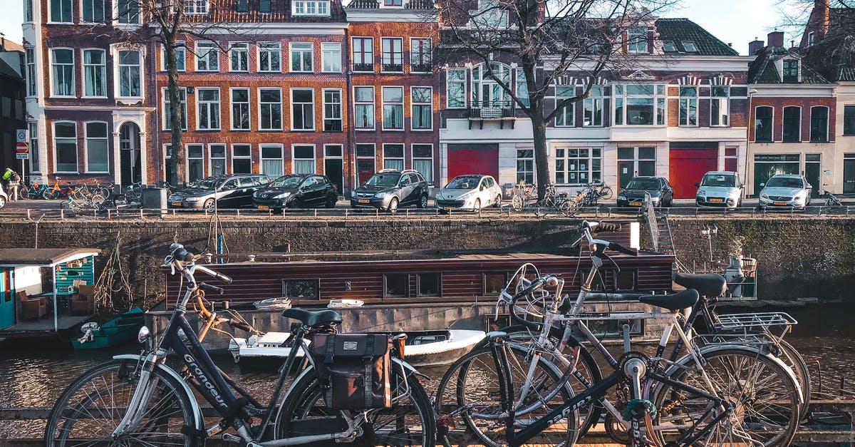 Dutch immigration at St Pancras intl - Bicycles Parked Beside Brown Wooden Fence Near A River Dutch immigration at St Pancras intl - Bicycles Parked Beside Brown Wooden Fence Near A River