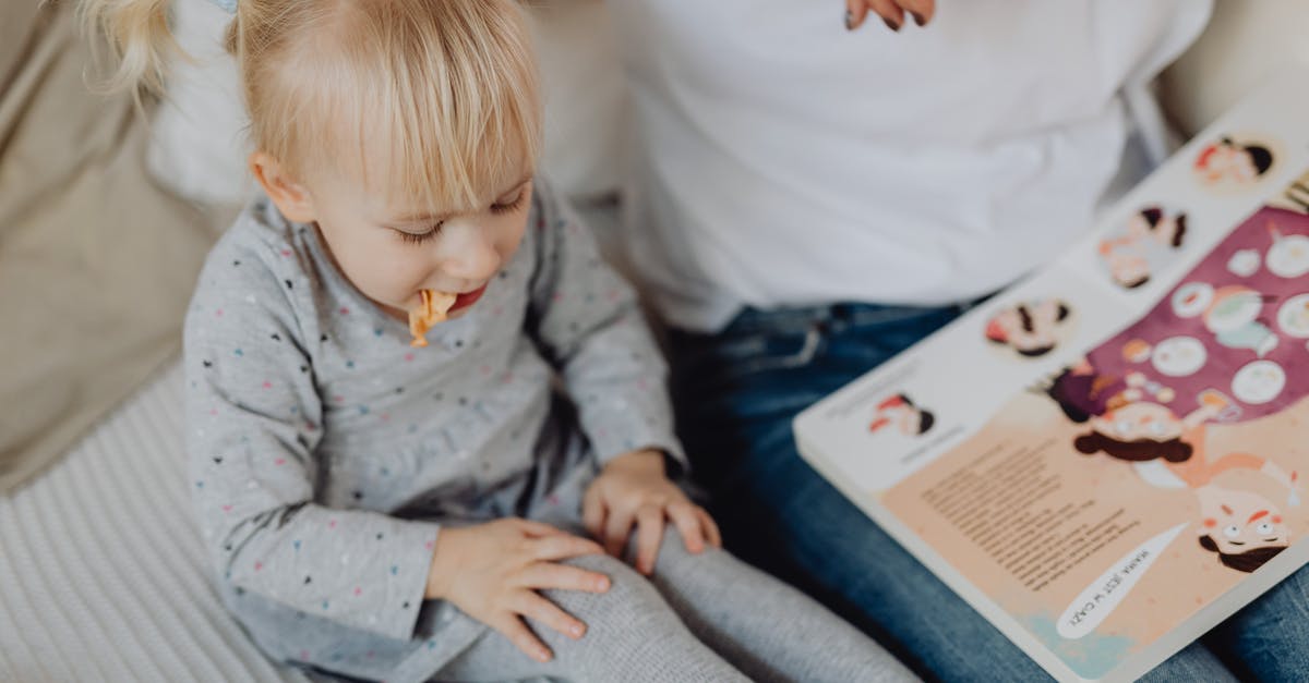 Eastbourne/Beachy Head with a toddler - Little Girl Eating Snacks on Bed Eastbourne/Beachy Head with a toddler - Little Girl Eating Snacks on Bed