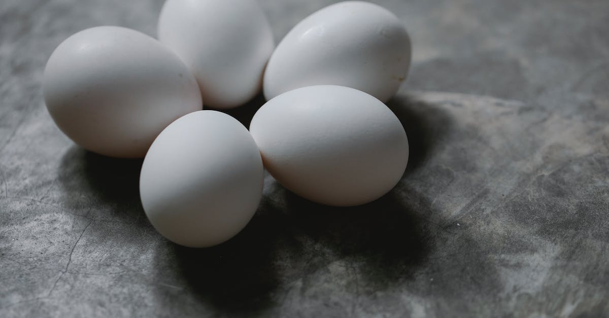 Easter breakfast in Chennai - Set of white uncooked eggs placed on marble surface Easter breakfast in Chennai - Set of white uncooked eggs placed on marble surface