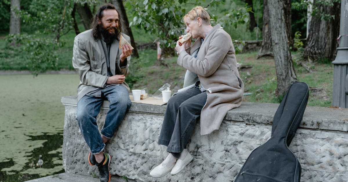 Eating while out on a public street in Japan - Man and Woman Eating at a Park Eating while out on a public street in Japan - Man and Woman Eating at a Park