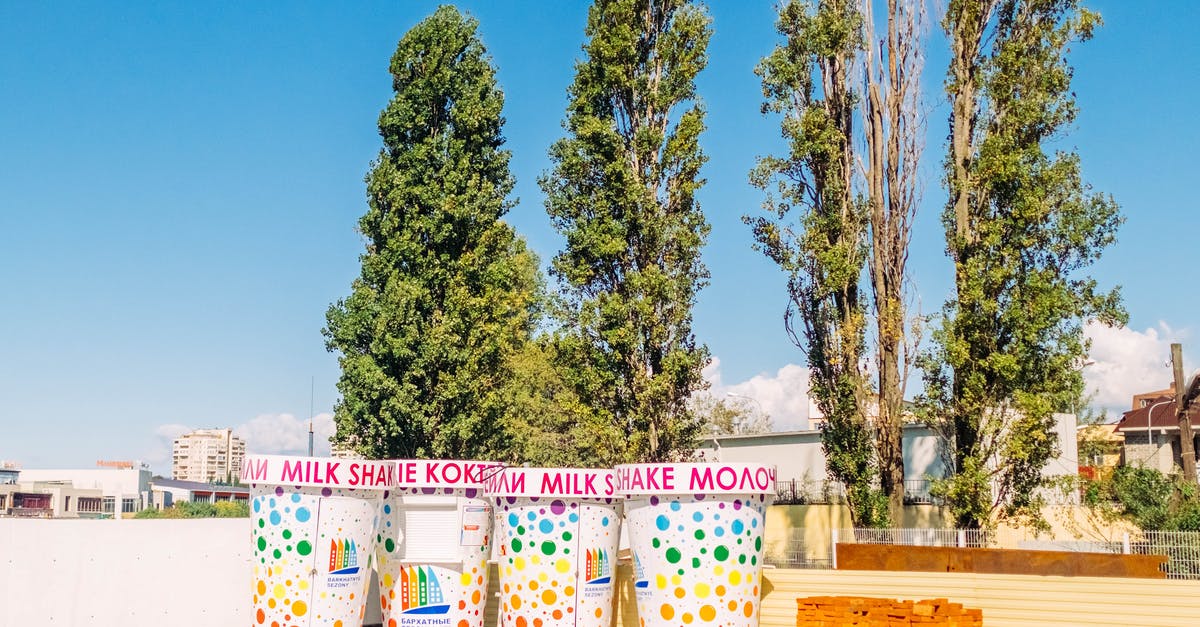Ecuadorian traveling to Sochi via Heathrow - Life-size Milkshake Cups Beside Green Trees Ecuadorian traveling to Sochi via Heathrow - Life-size Milkshake Cups Beside Green Trees