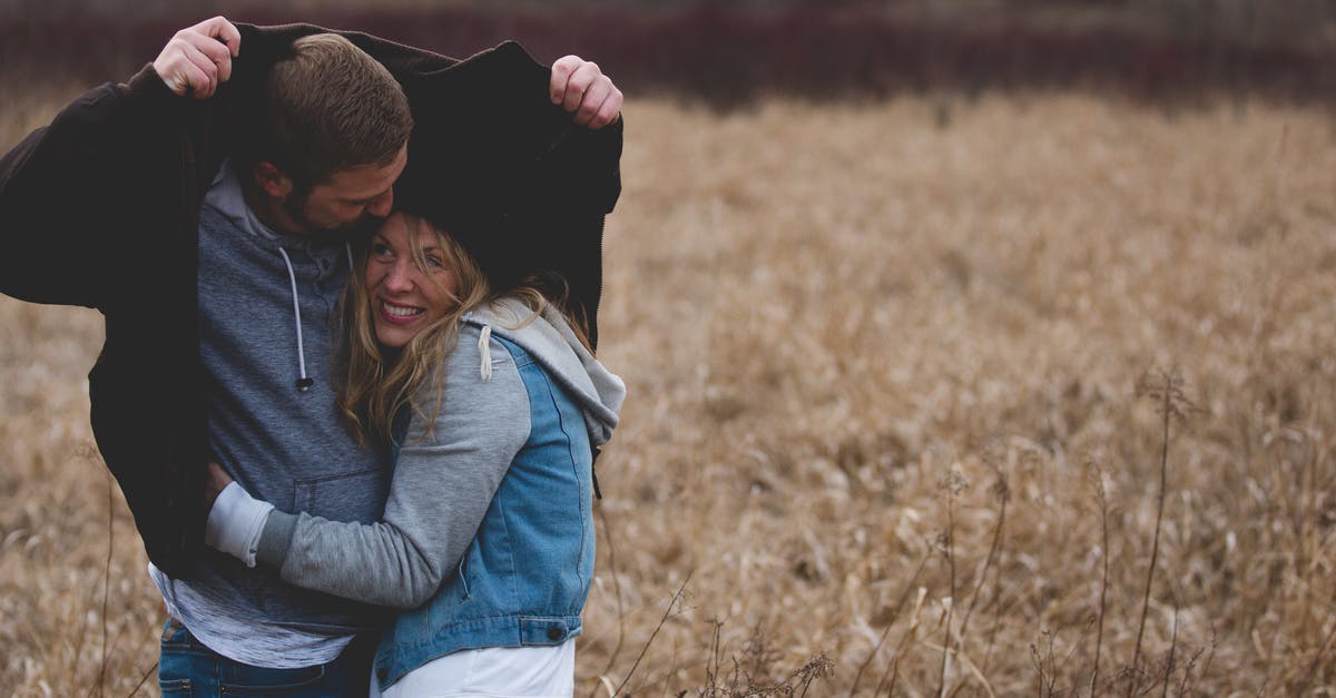 EEA Family Permit "Date of Arrival" Earliest request? - Man and Woman Hugging on Brown Field EEA Family Permit "Date of Arrival" Earliest request? - Man and Woman Hugging on Brown Field