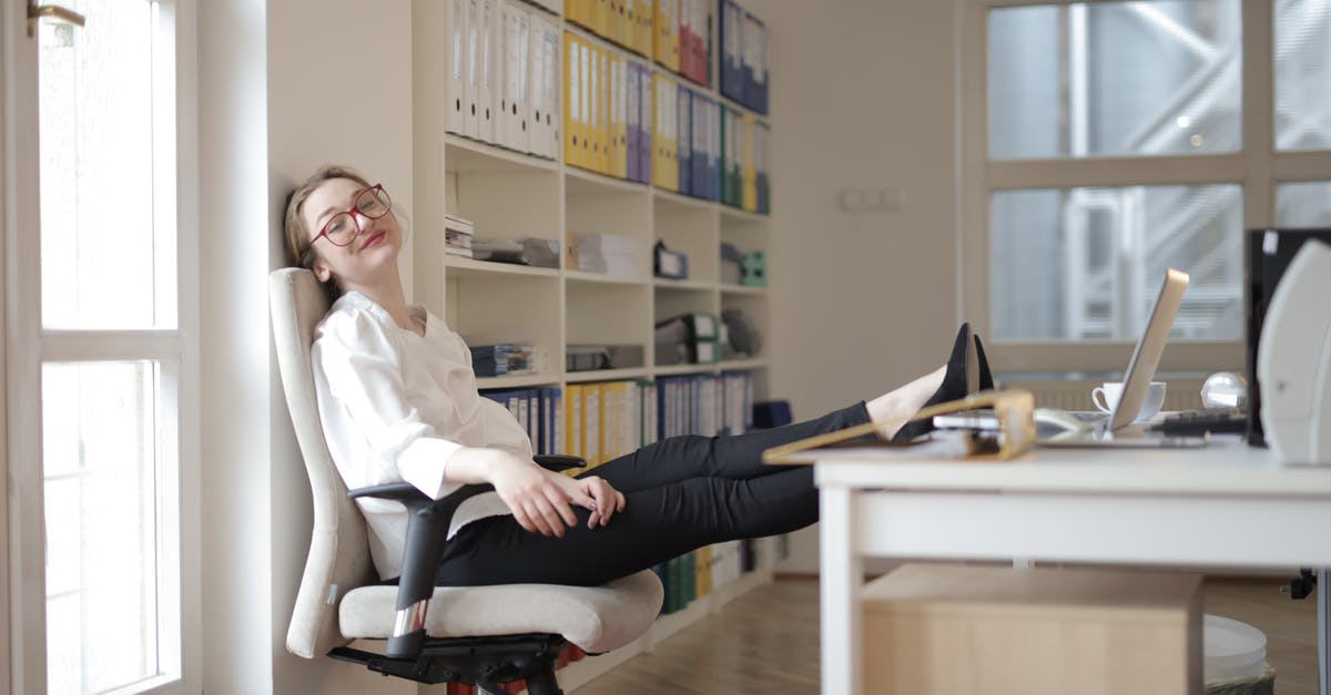 EEA family permit refusal - How to satisfy officer with my circumstances [closed] - Side view of content female employee wearing formal clothes and eyeglasses sitting on chair with crossed feet on table and chilling during work with closed eyes in modern office