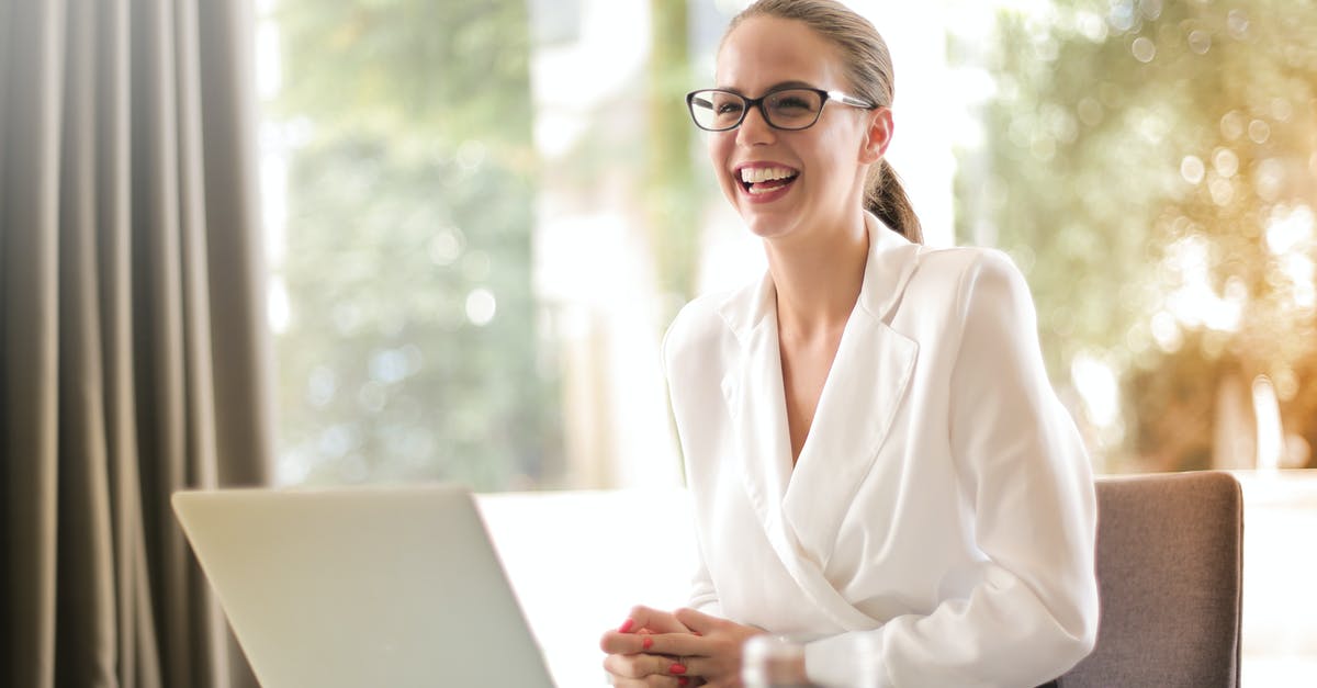 EEA family permit refusal - How to satisfy officer with my circumstances [closed] - Laughing businesswoman working in office with laptop
