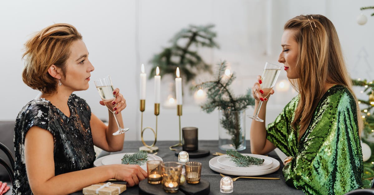 EEA family permit visa refusal: appeal or reapply? - Woman in Black and White Floral Dress Sitting on Chair in Front of Table With Plates EEA family permit visa refusal: appeal or reapply? - Woman in Black and White Floral Dress Sitting on Chair in Front of Table With Plates