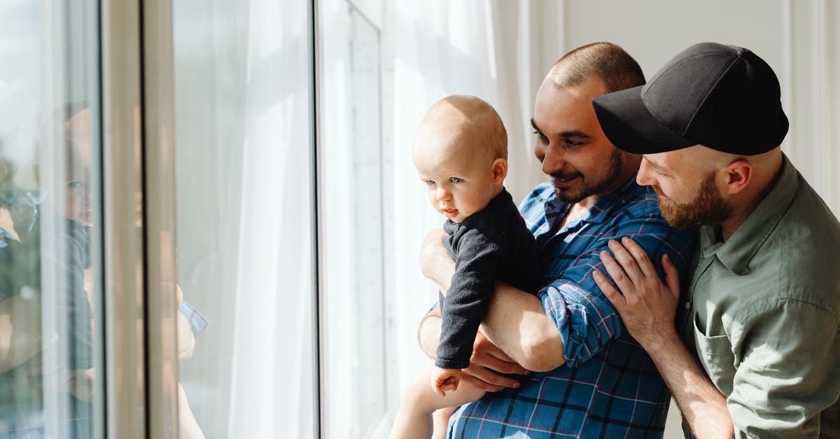 EEA family permit visa refusal: appeal or reapply? - Man in Blue and White Plaid Button Up Shirt Carrying Baby in Blue and White Plaid EEA family permit visa refusal: appeal or reapply? - Man in Blue and White Plaid Button Up Shirt Carrying Baby in Blue and White Plaid