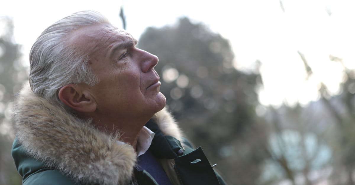 Elder person with hypertension flying first time. Anything we should know beforehand? - Man in Green Parka Jacket Looking Up the Sky