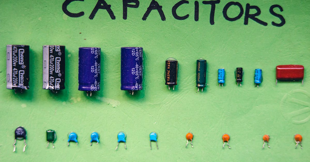 Electrical compatibility between different countries - Collection of capacitors on green surface Electrical compatibility between different countries - Collection of capacitors on green surface