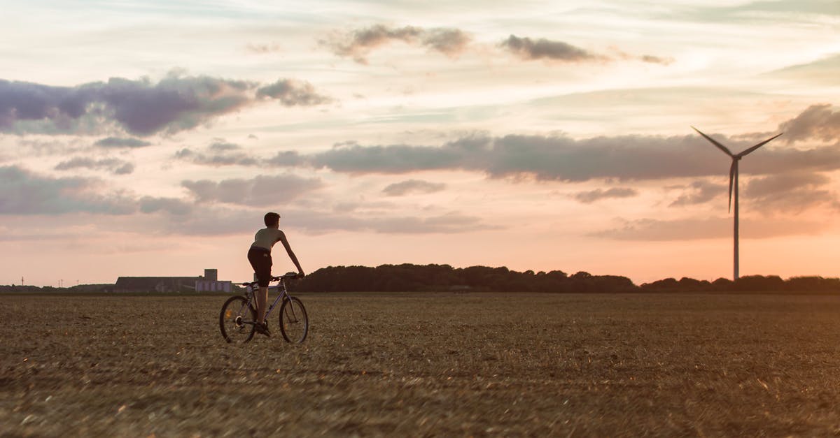 Electronic alternative to bicycle map - Man Cycling Near Wind Mill Electronic alternative to bicycle map - Man Cycling Near Wind Mill
