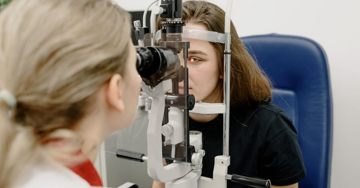 Electronic medical devices through British airport security - Female doctor using modern medical device for female patient while checking eyesight in clinic during check up Electronic medical devices through British airport security - Female doctor using modern medical device for female patient while checking eyesight in clinic during check up