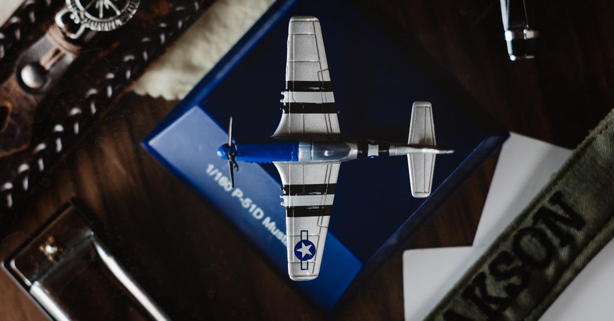 Eligibility for free overnight stay since Turkish Airlines cancelled return flight and rebooked me the next day - Overhead view of small blue figurine of aircraft on blue support surrounded by belts Eligibility for free overnight stay since Turkish Airlines cancelled return flight and rebooked me the next day - Overhead view of small blue figurine of aircraft on blue support surrounded by belts