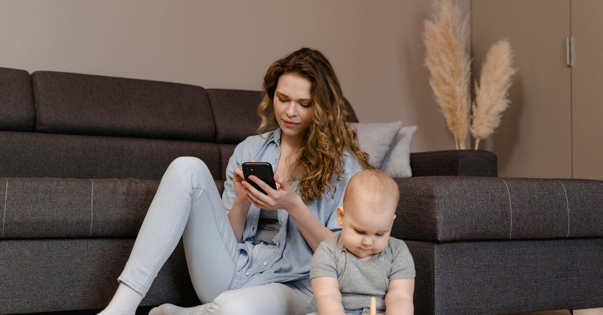 Eligibility to Invite Parent to Visit UK - Woman in Gray Long Sleeve Shirt and White Pants Sitting on Gray Couch Eligibility to Invite Parent to Visit UK - Woman in Gray Long Sleeve Shirt and White Pants Sitting on Gray Couch