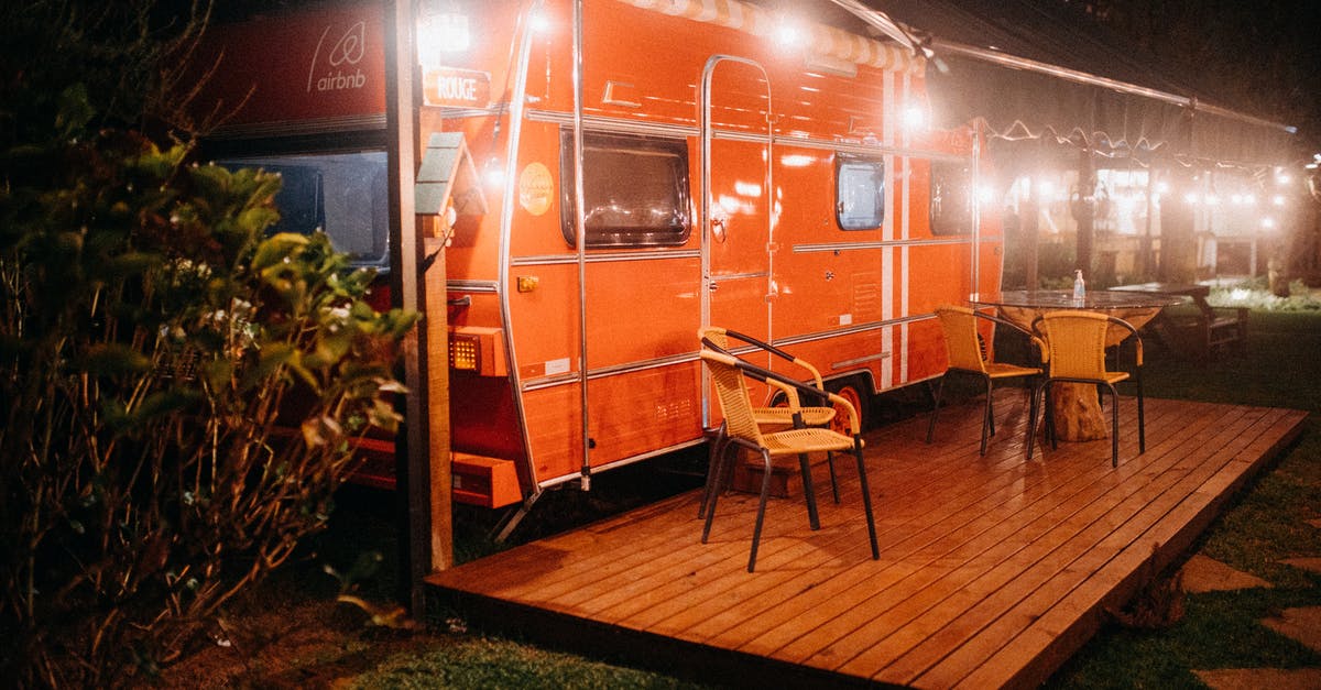 Enter Van Gogh Museum restaurant - Orange trailer with streetlights and table Enter Van Gogh Museum restaurant - Orange trailer with streetlights and table