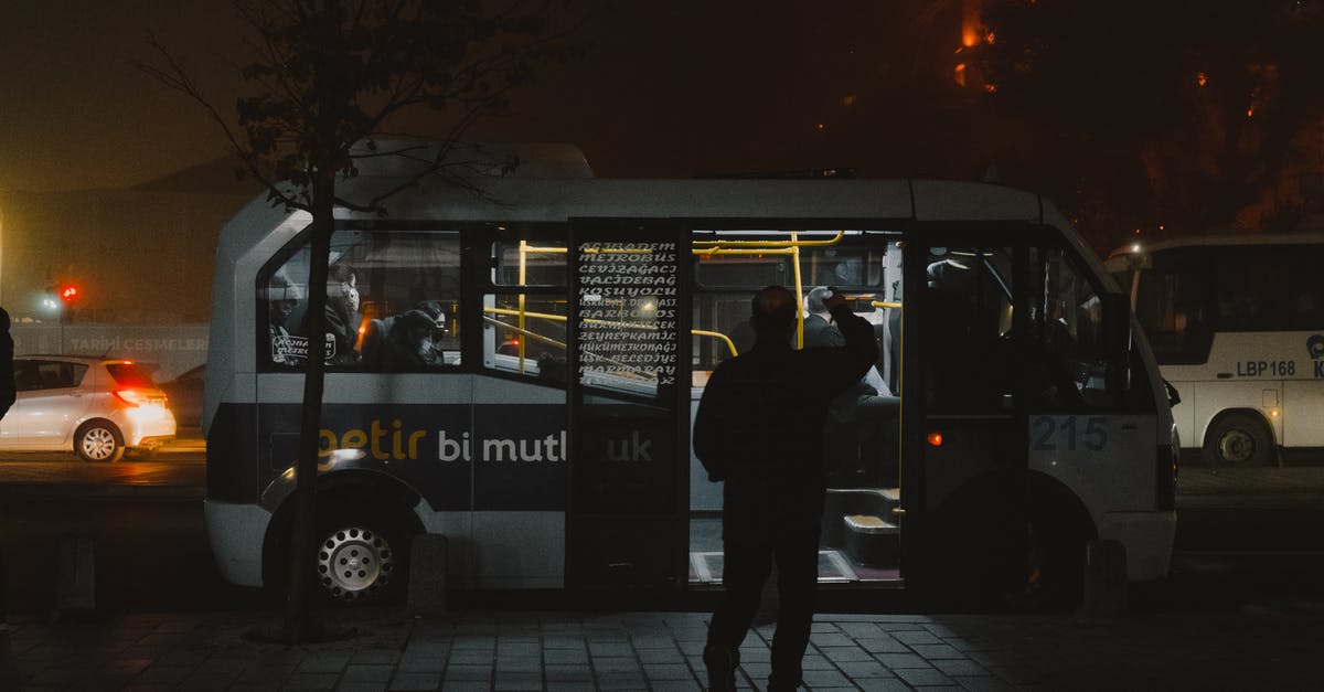 Entering Canada from the US by bus - Man in Black Jacket Standing Entering a Bus Entering Canada from the US by bus - Man in Black Jacket Standing Entering a Bus