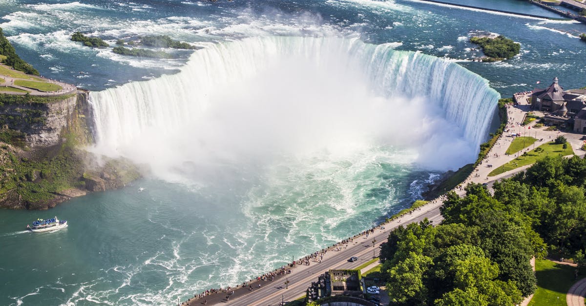 Entering Canada, Niagara border - Waterfalls Near Gray Paved Road Surrounded by Green Leaf Trees during Daytime