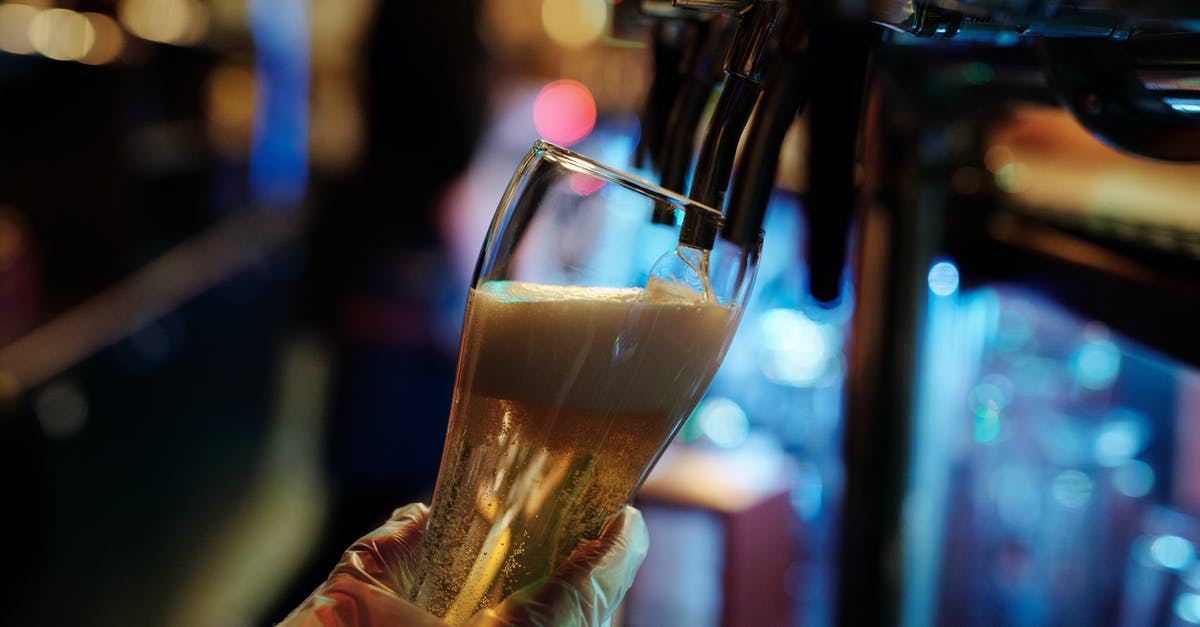 Entering Colombia with Alcohol - Person Holding Clear Drinking Glass With Brown Liquid Entering Colombia with Alcohol - Person Holding Clear Drinking Glass With Brown Liquid