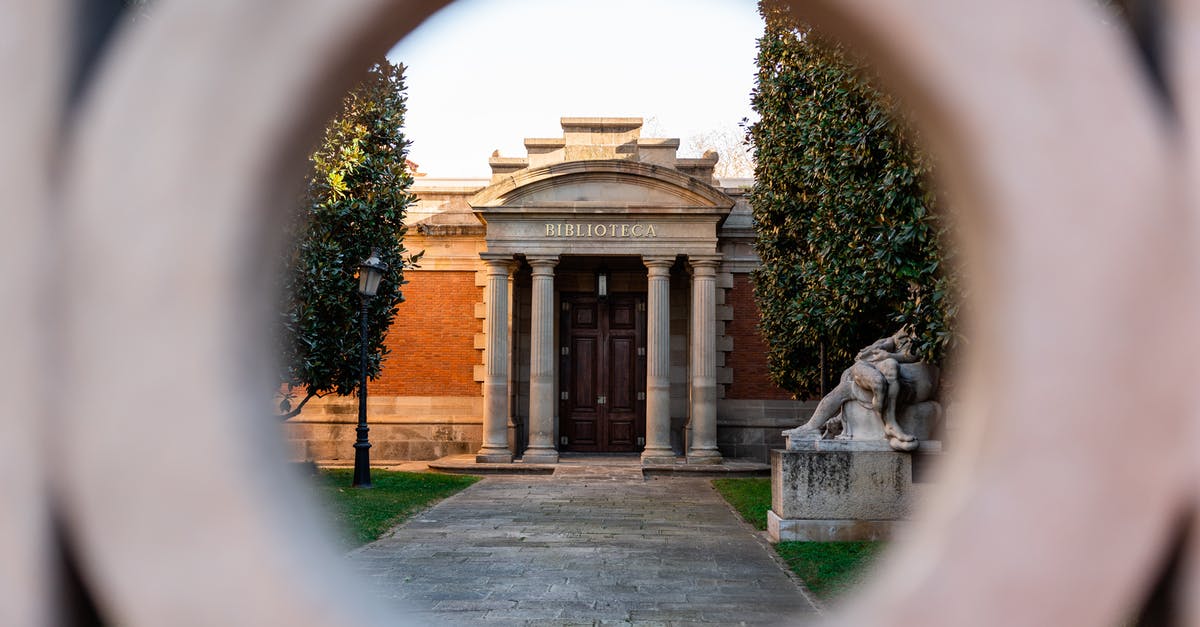 Entry to Europe Visa denial - View through hole of gate on stone library with columns near sculpture in park Entry to Europe Visa denial - View through hole of gate on stone library with columns near sculpture in park