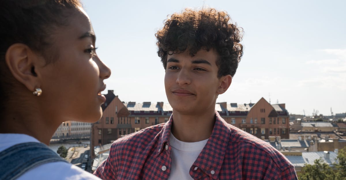 ESTA 90 day start date - Teenagers standing on rooftop talking and looking at each other ESTA 90 day start date - Teenagers standing on rooftop talking and looking at each other