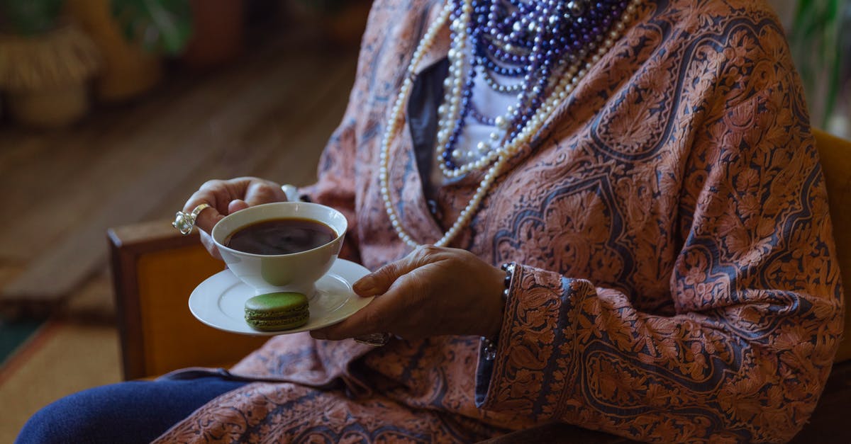 ESTA Elegible after Qatar? - Close-Up Photo of Person Holding Cup of Coffee ESTA Elegible after Qatar? - Close-Up Photo of Person Holding Cup of Coffee