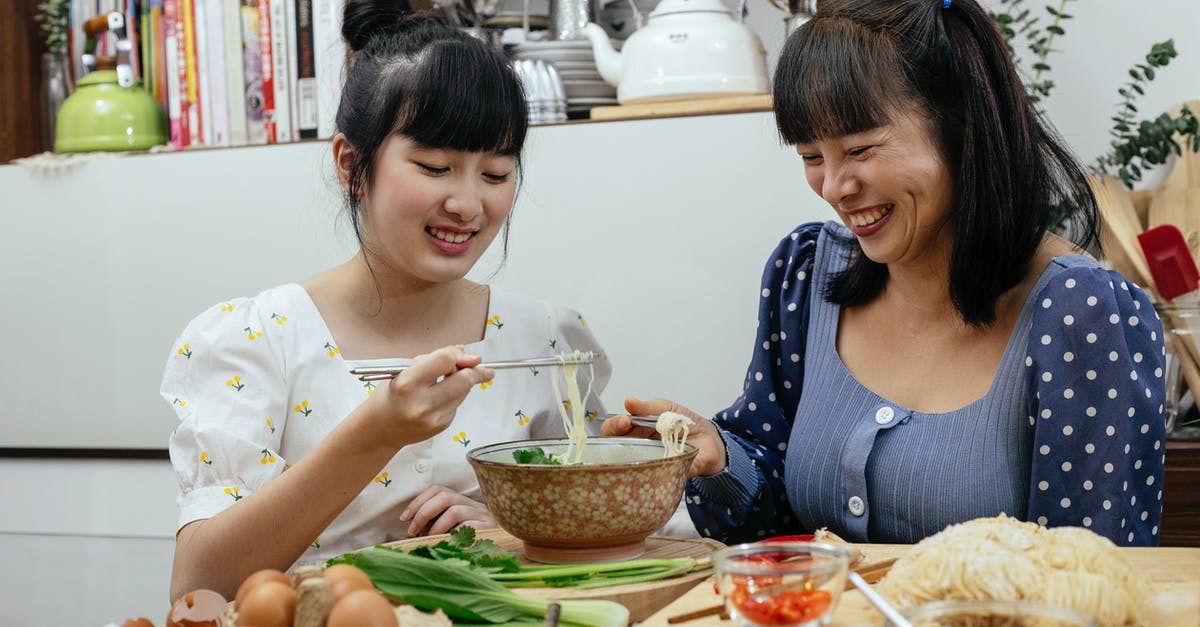 Etiquette of eating noodle soup in China - Joyful Asian women eating traditional noodles soup together Etiquette of eating noodle soup in China - Joyful Asian women eating traditional noodles soup together