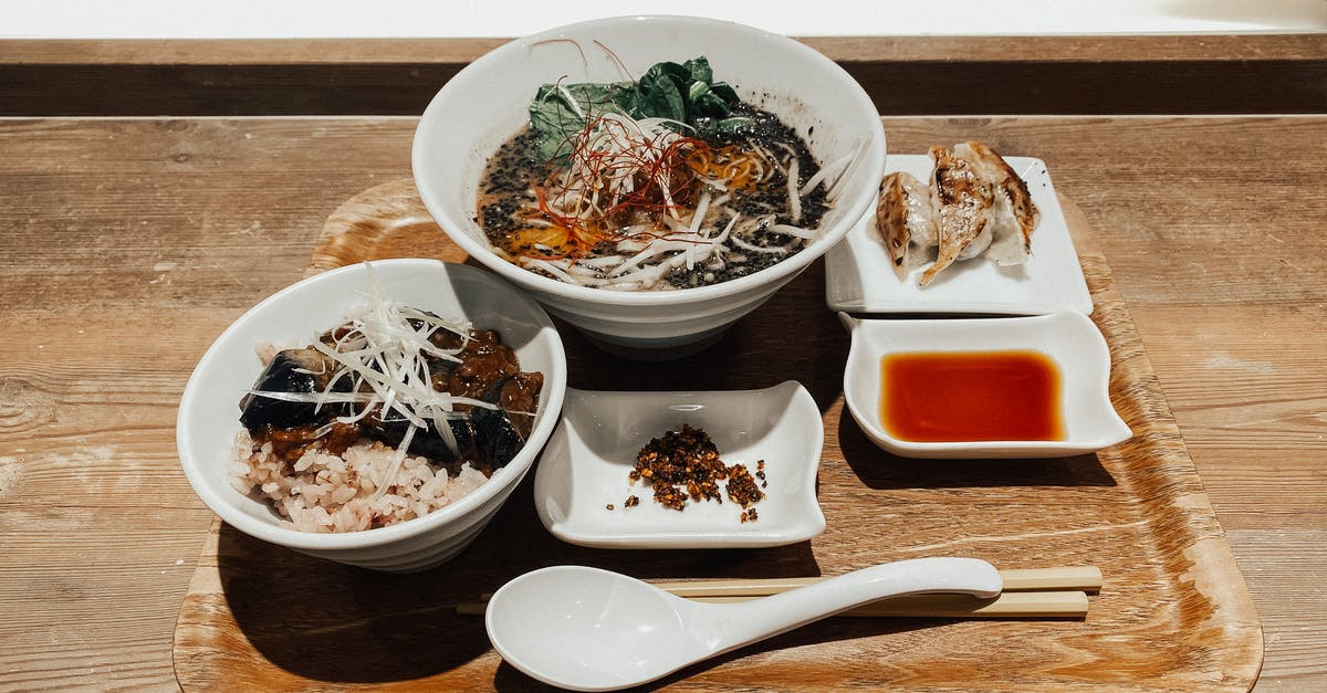 Etiquette of eating noodle soup in China - Delicious traditional Asian soup and rice with vegetables served on tray Etiquette of eating noodle soup in China - Delicious traditional Asian soup and rice with vegetables served on tray