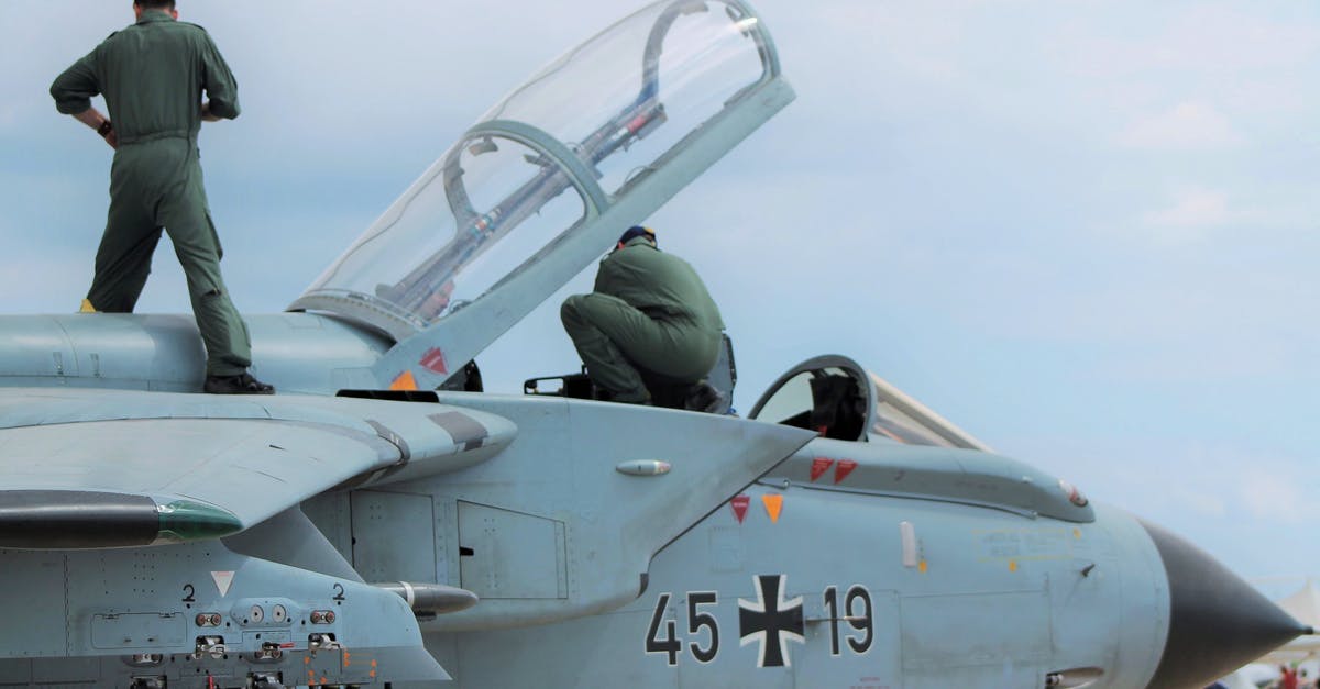Eu 261 query on multi flight ticket during BA pilots strike - Low angle of unrecognizable male pilots in uniforms standing on aged gray multirole combat aircraft before flight against cloudy sunset sky Eu 261 query on multi flight ticket during BA pilots strike - Low angle of unrecognizable male pilots in uniforms standing on aged gray multirole combat aircraft before flight against cloudy sunset sky