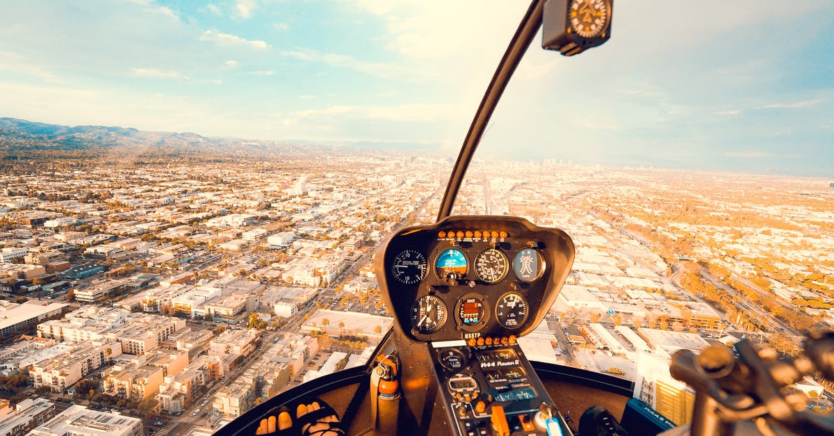 EU Air Passenger Rights for connecting flight - Crop anonymous female traveler sitting in cockpit of modern helicopter and admiring spectacular view of city on sunny day EU Air Passenger Rights for connecting flight - Crop anonymous female traveler sitting in cockpit of modern helicopter and admiring spectacular view of city on sunny day