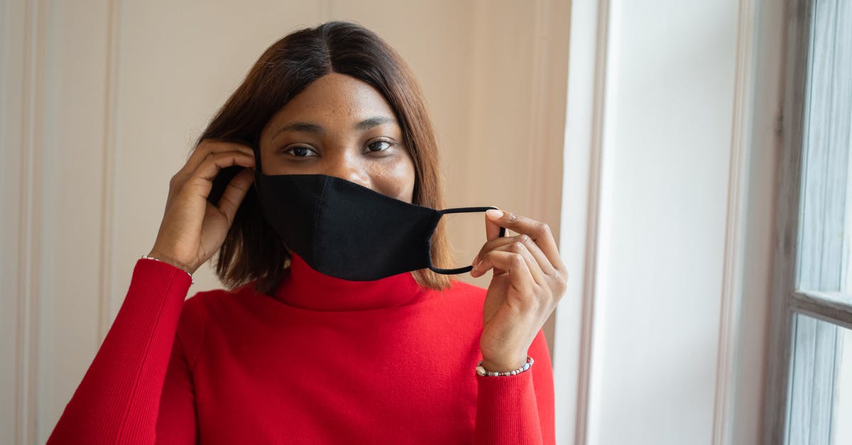 EU DCC/covid restrictions and layovers - Woman in protective mask in light room EU DCC/covid restrictions and layovers - Woman in protective mask in light room